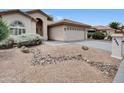 Desert landscaping featuring gravel and decorative rock elements around a cozy home at 9437 E Champagne Dr, Sun Lakes, AZ 85248