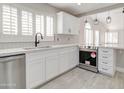 Modern kitchen showcasing stainless steel appliances, marble counter tops, and crisp white cabinets at 9437 E Champagne Dr, Sun Lakes, AZ 85248