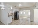 Bright eat-in kitchen featuring white cabinets, sleek appliances, and tile flooring at 1129 E South Mountain Ave, Phoenix, AZ 85042