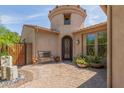 Inviting home exterior with a turret entry and a cozy bench seating area at 12098 W Lone Tree Trl, Peoria, AZ 85383
