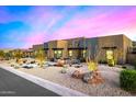 Beautiful single-Gathering home featuring desert landscaping, drought resistant shrubs, and a stone-gray facade at 12857 E Rosewood Dr, Scottsdale, AZ 85255