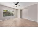 Spacious, naturally lit bedroom with tile flooring, a ceiling fan, and a large window at 1421 E Hopkins Rd, Gilbert, AZ 85295