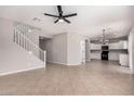 Bright, open-concept living room with tile flooring and stairs leading to the second floor at 1421 E Hopkins Rd, Gilbert, AZ 85295