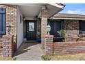 Inviting brick porch and decorative front door with climbing vines enhancing curb appeal at 1656 E Halifax St, Mesa, AZ 85203