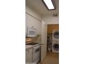 Cozy kitchen features essential appliances adjacent to a convenient laundry area at 1701 E Colter St # 191, Phoenix, AZ 85016