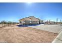 A desert home with a brick-paved driveway, three car garage and wrought iron fence at 1727 E Hidalgo St, Apache Junction, AZ 85119