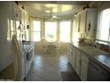 Sunlit eat-in kitchen features white cabinetry, modern appliances, and a breakfast nook with bay windows at 19420 N Westbrook Pkwy # 510, Peoria, AZ 85382