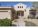 Welcoming front entrance with desert landscaping and a secure screen door at 28604 N 92Nd Pl, Scottsdale, AZ 85262