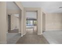 Open living area with tiled floors and plush carpeting, leading to sliding glass doors at 28604 N 92Nd Pl, Scottsdale, AZ 85262