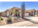 Attractive home featuring desert landscaping, a tile roof, and a spacious driveway at 4245 E Maya Way, Cave Creek, AZ 85331