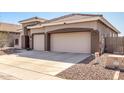 Spacious three-car garage with neutral-colored doors and a large concrete driveway at 4245 E Maya Way, Cave Creek, AZ 85331