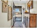 Inviting entryway featuring neutral walls, tile flooring, and an antique wooden cabinet with decorative lamp at 5141 E Elena Ave, Mesa, AZ 85206