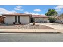 Charming single-story brick home with a tile roof and desert landscaping in a well-maintained neighborhood at 5141 E Elena Ave, Mesa, AZ 85206