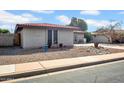 A beautiful brick home featuring desert landscaping with rocks and plants along the side of the house at 5141 E Elena Ave, Mesa, AZ 85206