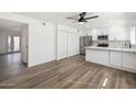 Spacious living area with wood-look floors and modern fixtures adjacent to a kitchen and dining area at 6173 N Granite Reef Rd, Scottsdale, AZ 85250