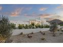 Modern home exterior with lush landscaping and a white facade that blends seamlessly with the natural surroundings at 6601 E San Miguel Ave, Paradise Valley, AZ 85253