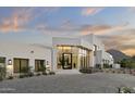 Inviting home exterior featuring a modern design, manicured landscaping, and a spacious paved driveway at 6601 E San Miguel Ave, Paradise Valley, AZ 85253