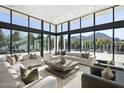 Bright living room with floor-to-ceiling windows and comfortable seating, offering stunning outdoor views at 6601 E San Miguel Ave, Paradise Valley, AZ 85253