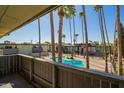 Balcony view overlooking the community pool with several palm trees surrounding the area at 6767 N 7Th St # 212, Phoenix, AZ 85014