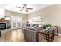 Inviting living room featuring modern furniture, ceiling fan, and fireplace at 7021 E Earll Dr # 223, Scottsdale, AZ 85251
