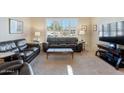 Comfortable living room with plush seating and a large window offering plenty of natural light at 804 N Jamaica Way, Gilbert, AZ 85234