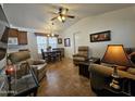 Cozy living room featuring vaulted ceilings, neutral tones, and comfortable seating arrangements, creating a welcoming ambiance at 8700 E University Dr # 1024, Mesa, AZ 85207