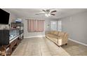 Open-concept living room featuring neutral walls and tile floors, ideal for entertaining guests at 907 N Menze St, Casa Grande, AZ 85122