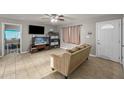 Comfortable living room with ceiling fan, neutral paint, and tile flooring throughout the home at 907 N Menze St, Casa Grande, AZ 85122