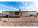 Exterior view of home with a chain-link fence and low-maintenance gravel yard at 9139 E Aspen Ave, Mesa, AZ 85208