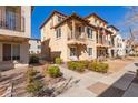 Inviting two-story townhome showcasing a cozy balcony, well-maintained shrubs, and sidewalk access at 925 S Storment Ln, Gilbert, AZ 85296