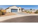 Inviting single-story home with a two-car garage, desert landscaping, and a concrete driveway in a quiet neighborhood at 1060 W Castle Ct, Casa Grande, AZ 85122