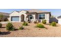 Lovely single-story home with desert landscaping, covered porch, and a two-car garage, offering curb appeal and comfort at 1060 W Castle Ct, Casa Grande, AZ 85122