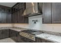 A spacious kitchen with stainless steel range hood, gas range and granite countertops at 11529 N 170Th Ln, Surprise, AZ 85388