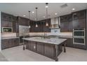 Modern kitchen featuring stainless steel appliances, ample counter space, and a kitchen island at 11529 N 170Th Ln, Surprise, AZ 85388