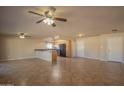 Spacious living room with neutral paint, tile floors, and ceiling fans, creating a welcoming atmosphere at 13134 N 20Th Ave, Phoenix, AZ 85029