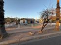 Exterior showcasing the home's facade, fenced yard, and landscaping at 1434 E Roosevelt St, Phoenix, AZ 85006