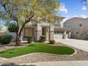 Charming home with stone accents and a well-maintained lawn at 14425 N 137Th Ln, Surprise, AZ 85379