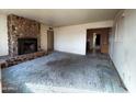 Living room with stone fireplace and view to hallway and kitchen at 1466 E Nielson Ave, Mesa, AZ 85204