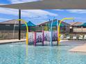 Fun splash pad area with colorful water features and seating for residents to enjoy at 16071 W Remuda Dr, Surprise, AZ 85387