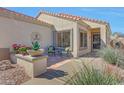 Inviting front porch with seating area, decorative plants, and stylish accents, creating a welcoming entrance at 17210 N Firestone Ln, Surprise, AZ 85374