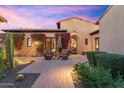 Beautiful outdoor living space with a stone patio, stylish seating, desert landscaping and sunset views at 18683 N 101St Pl, Scottsdale, AZ 85255