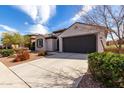 Beautiful single-story home boasts a well-maintained lawn, a paved driveway, and an attached two-car garage at 19919 W Harrison St, Buckeye, AZ 85326