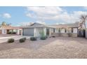 Traditional single-story home with low maintenance landscaping and a gray two car garage at 2016 N Pennington Dr, Chandler, AZ 85224