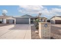 A charming single-story home featuring a gray garage door and low maintenance landscaping at 2016 N Pennington Dr, Chandler, AZ 85224