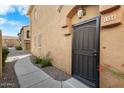 Close-up of a townhome's secure front door with a security screen and stylish exterior lighting at 2150 E Bell Rd # 1134, Phoenix, AZ 85022