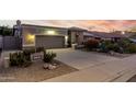 Attractive single-story home with desert landscaping, a two car garage, and a spacious driveway at 2169 E Alameda Dr, Tempe, AZ 85282