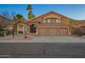 Charming two-story home with desert landscaping, a three-car garage, and a tile roof at 2633 E Amber Ridge Way, Phoenix, AZ 85048