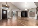 Bright living room with vaulted ceilings, hardwood floors, and large windows at 2633 E Amber Ridge Way, Phoenix, AZ 85048