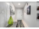 Inviting entryway with neutral walls, decorative accents and a white front door at 2744 E Windrose Dr, Phoenix, AZ 85032