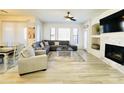 Bright living room with a corner fireplace, neutral color palette, and wood-look tile flooring at 3131 E Legacy Dr # 2105, Phoenix, AZ 85042